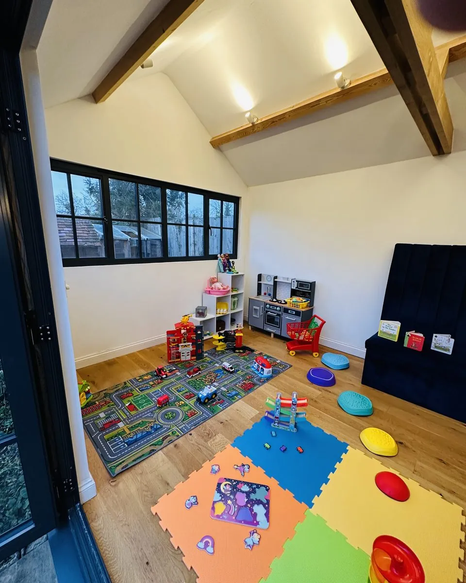 Inside the Chatty Sprouts therapy studio in Marden, with a road play mat, toy kitchen, books and sensory stepping stones.